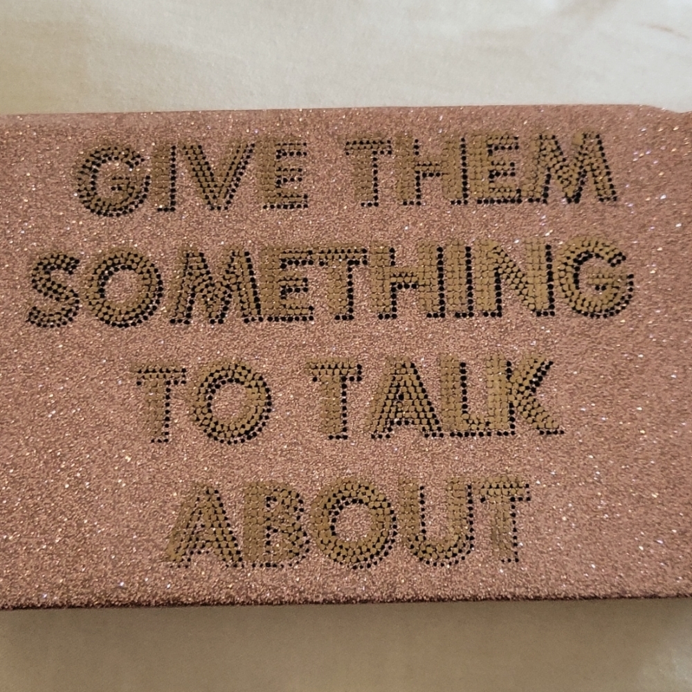 A glasses case, sparkly pink w/ cute saying 'Give them something to talk about'